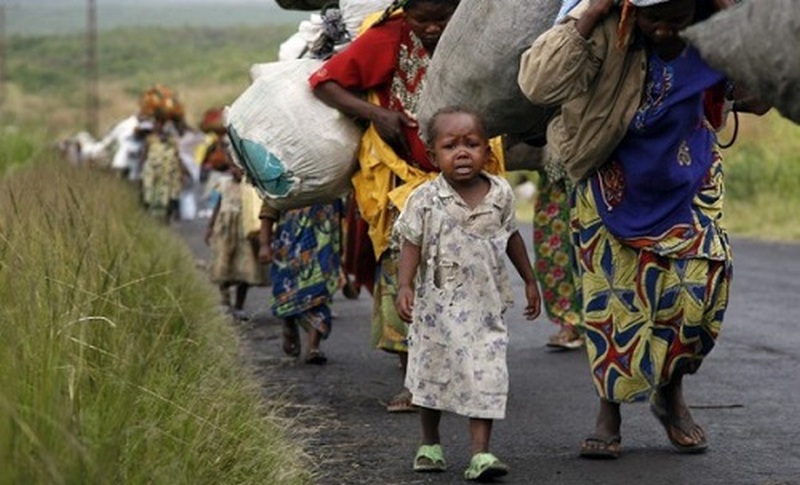 Congolese flee the eastern town of Sake, just west of Goma, on Friday. Fighting between rebel and government forces in the east of the Democratic Republic of Congo has displaced at least 100,000 people.