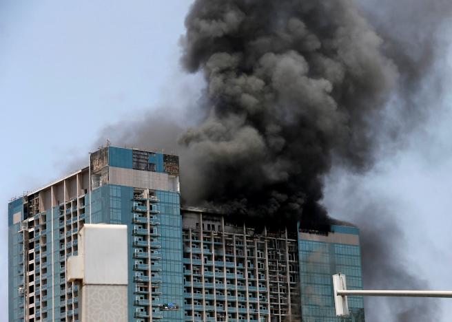 Smoke rises after a fire broke out in a building at Al Maryah Island in Abu Dhabi, UAE, August 30, 2016. REUTERS/Stringer