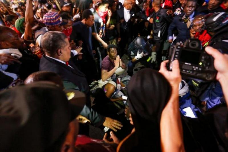 People surround a shooting victim in uptown Charlotte, NC during a protest of the police shooting of Keith Scott, in Charlotte, North Carolina, U.S. September 21, 2016. REUTERS/Jason Miczek