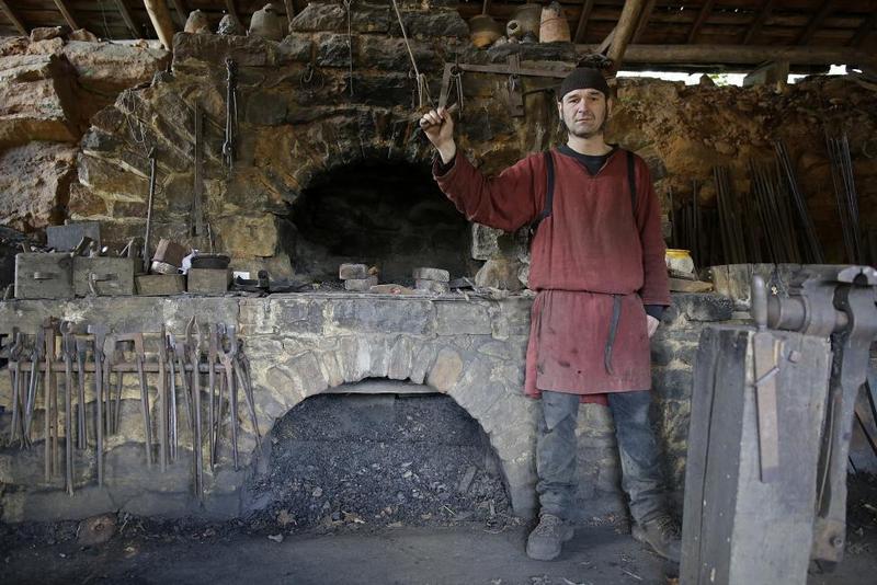 Clement Guerard, blacksmith at the site since 1999, poses in his workshop at the construction site of the Chateau de Guedelon.  REUTERS/Jacky Naegelen