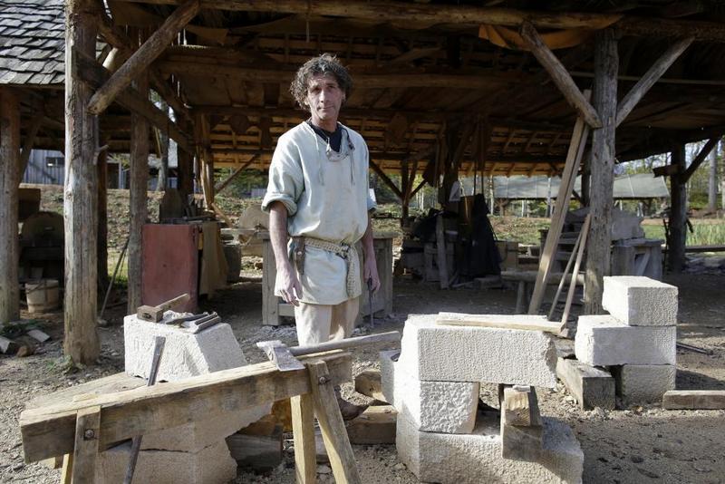 Stonecutter Eugene Kedadra poses in his workshop at the construction site.  REUTERS/Jacky Naegelen