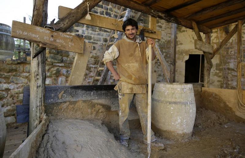 Mason Guillaume Glotin poses in his workshop at the construction site.  REUTERS/Jacky Naegelen