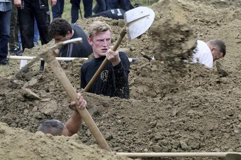 Grave diggers compete during the Grave Digging Championships in Trencin, Slovakia, Thursday, Nov. 10, 2016. (AP Photo/Ronald Zak)