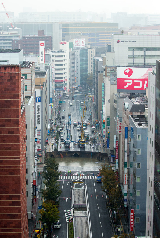 epa05621789 A large sinkhole cuts off an avenue in central Fukuoka, southwestern Japan, 08 November 2016. According to local media reports, the sinkhole has caused blackouts and disrupted traffic. Authorities have evacuated surrounding buildings in case of further damage. There were no immediate reports of damage or injuries.  EPA/HIROSHI YAMAMURA