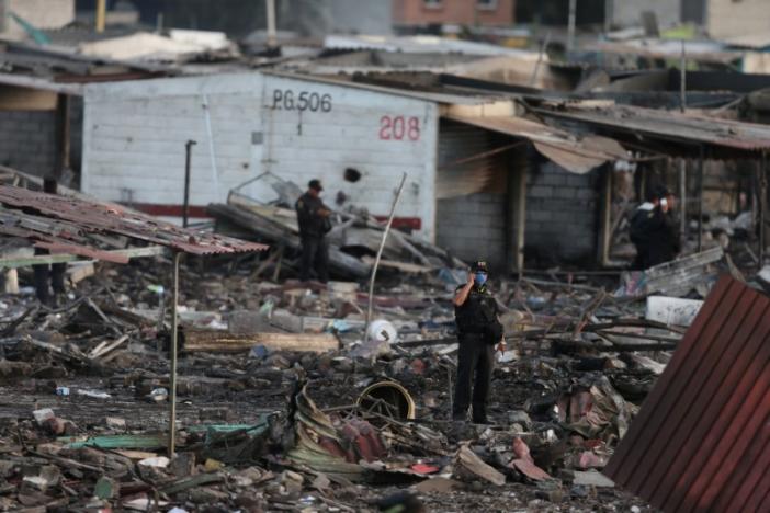 A police officer talks on his mobile phone while standing amidst the wreckage of houses destroyed in an explosion at the San Pablito fireworks market outside the Mexican capital on Tuesday, in Tultepec, Mexico, December 20, 2016. REUTERS/Edgard Garrido