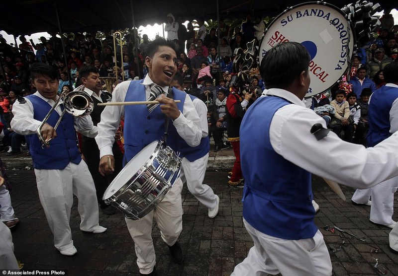 A band plays during "La Diablada" festival in Pillaro, Ecuador, Friday, Jan. 6, 2017. A procession of dancers in elaborate devil masks is the centerpiece of an annual festival (AP Photo/Dolores Ochoa)