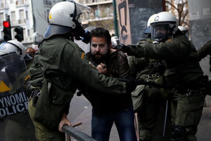 A farmer from the island of Crete is detained by riot police during clashes outside the Agriculture Ministry in Athens, Greece March 8, 2017. REUTERS/Alkis Konstantinidis