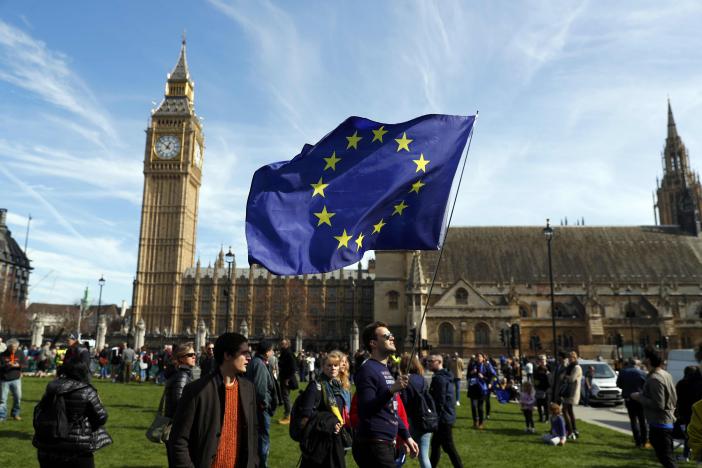 Demonstrators wave a flag in Parliament Square as they take part in a Unite for Europe march, in central London, Britain March 25, 2017. REUTERS/Peter Nicholls