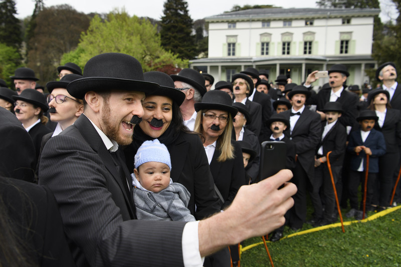 epa05910682 Some 662 people dressed as Charlie Chaplin pose for a group photo in front of the Manoir de Ban during an attempt of the world's largest gathering of people dressed as 'The Tramp' on the occasion of Charlie Chaplin's birthday, and to celebrate the first year of the museum "Chaplin's World by Grevin", in Corsier, above Vevey, Switzerland, 16 April 2017. Chaplin's World, a museum on English comic actor, filmmaker, and composer Charlie Chaplin, is located in a 14 hectare park of lush trees, it occupies the mansion where the Chaplin family lived the last 25 years of Charly Chaplin's life. EPA/LAURENT GILLIERON