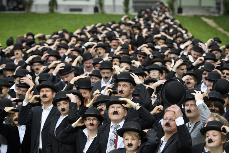 epa05910608 Over 662 people dressed as Charlie Chaplin pose for a group photo in front of the Manoir de Ban during an attempt of the world's largest gathering of people dressed as 'The Tramp' on the occasion of Charlie Chaplin's birthday, and to celebrate the first year of the museum "Chaplin's World by Grevin", in Corsier, above Vevey, Switzerland, 16 April 2017. Chaplin's World, a museum on English comic actor, filmmaker, and composer Charlie Chaplin, is located in a 14 hectare park of lush trees, it occupies the mansion where the Chaplin family lived the last 25 years of Charly Chaplin's life. EPA/LAURENT GILLIERON