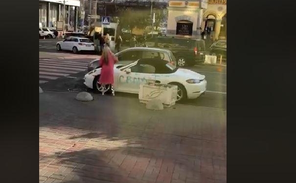 Не огорчайте женщин: в центре Киева девушка писала на  Porsche ругательства и рубила его топором