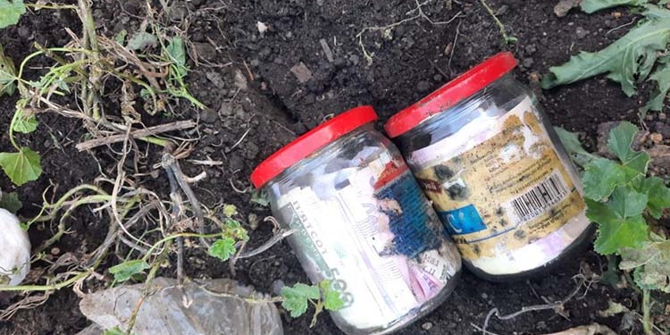 Жінка звинуватила сусіда у крадіжці заощаджень, які закопала на городі. Поліція банки знайшла, але осад залишився (ФОТО)